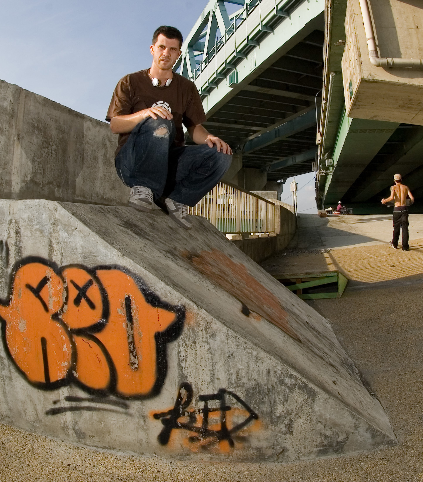 Vaughan at a concrete bank beneath an urban bridge