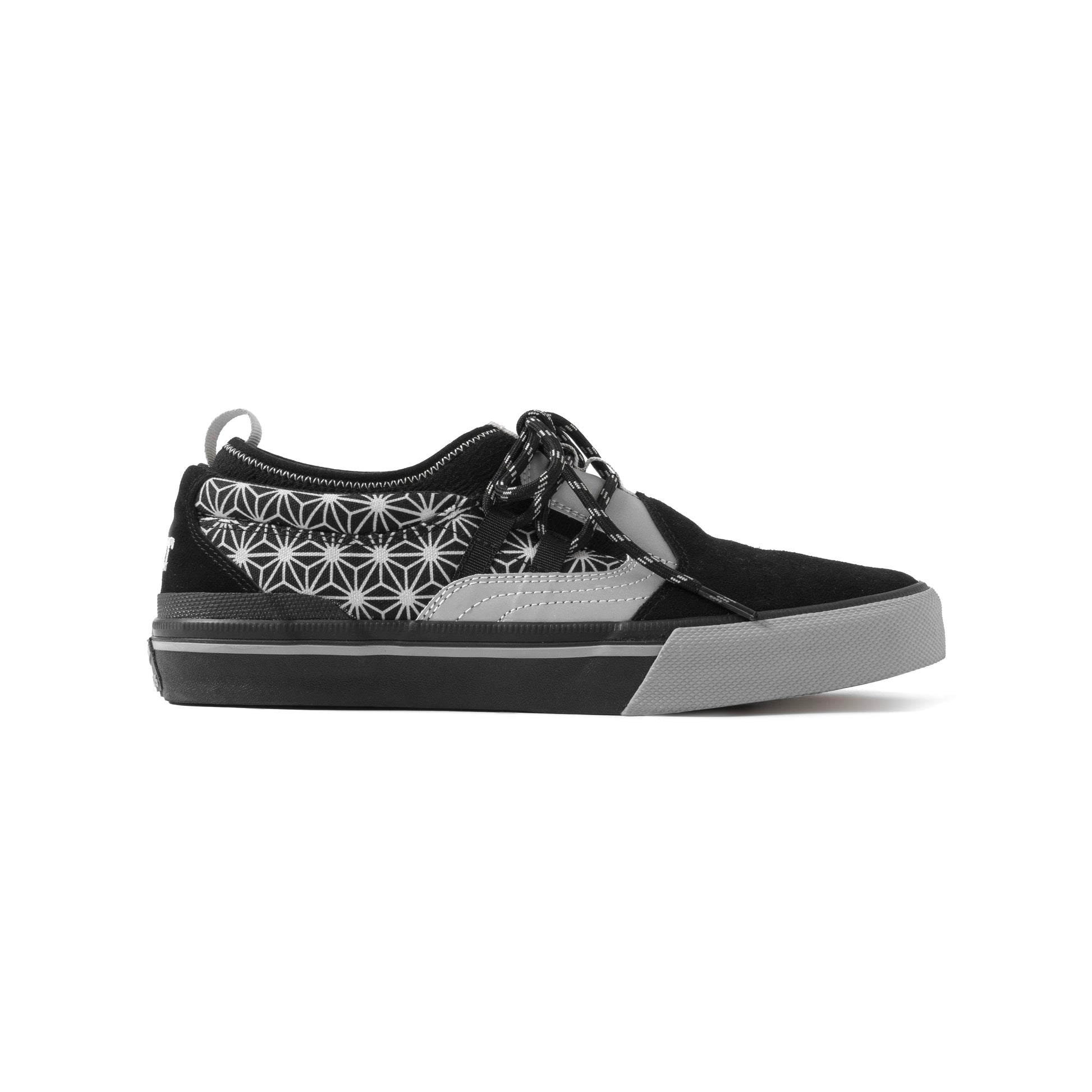 Black sneaker with white geometric pattern on a white background